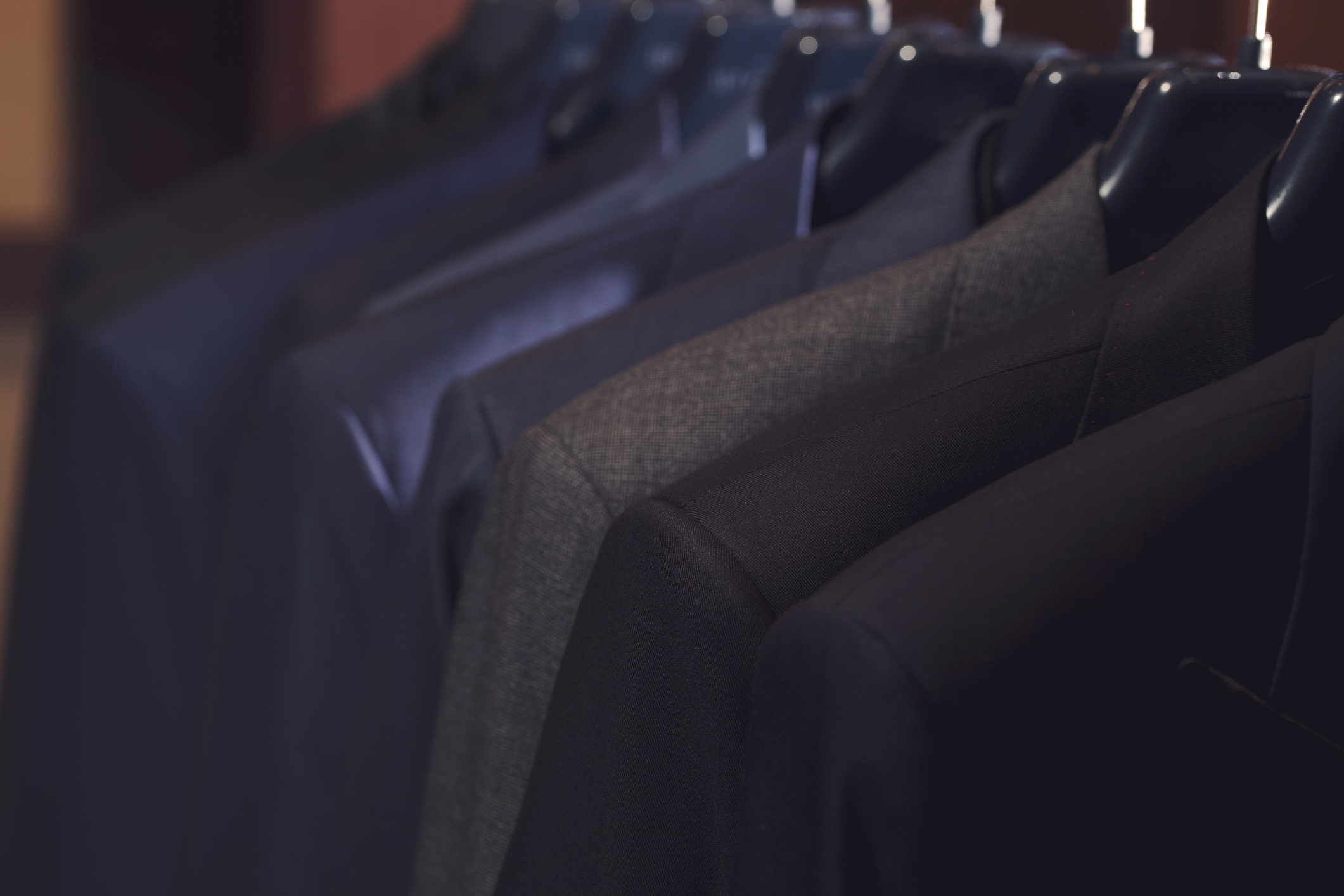 many suits on rack